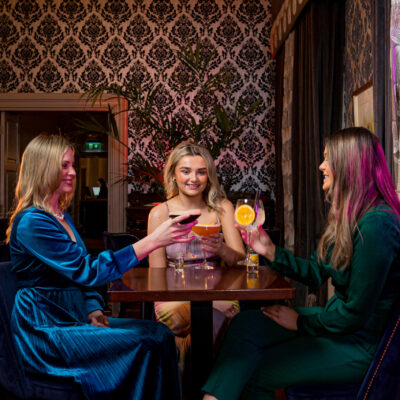 3 Girls drinking cocktails in Aylward Lounge middle bar Faithlegg